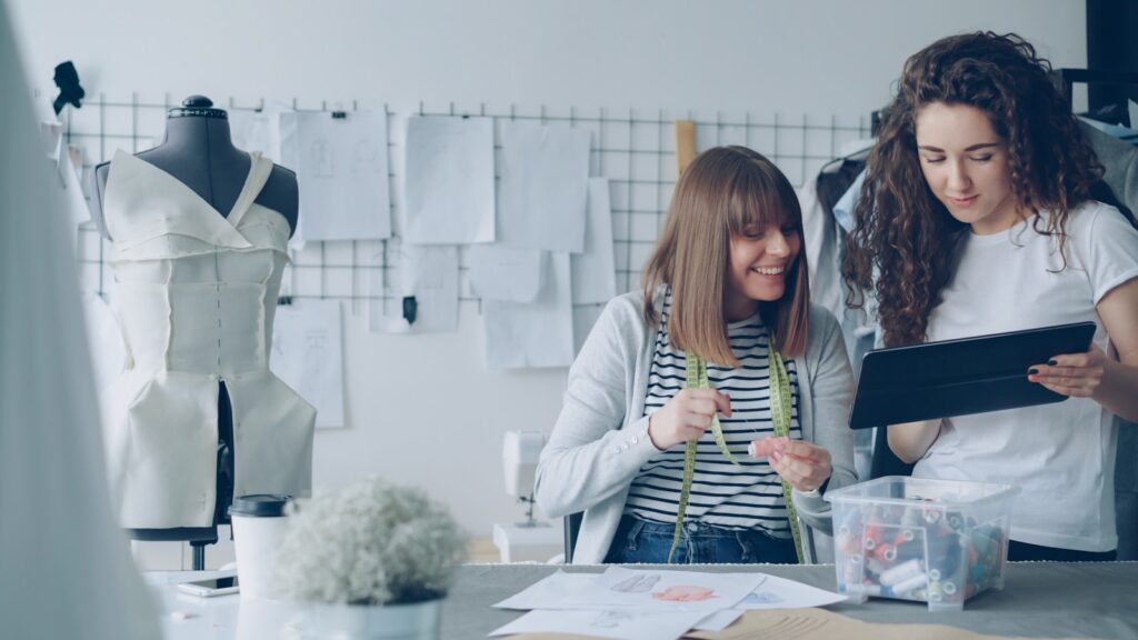 Two designers collaborate in a fashion studio.