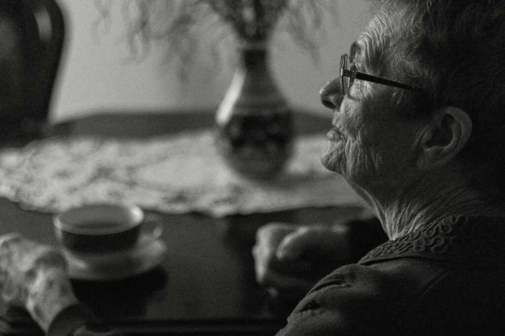 a woman sitting at a table with a cup of coffee