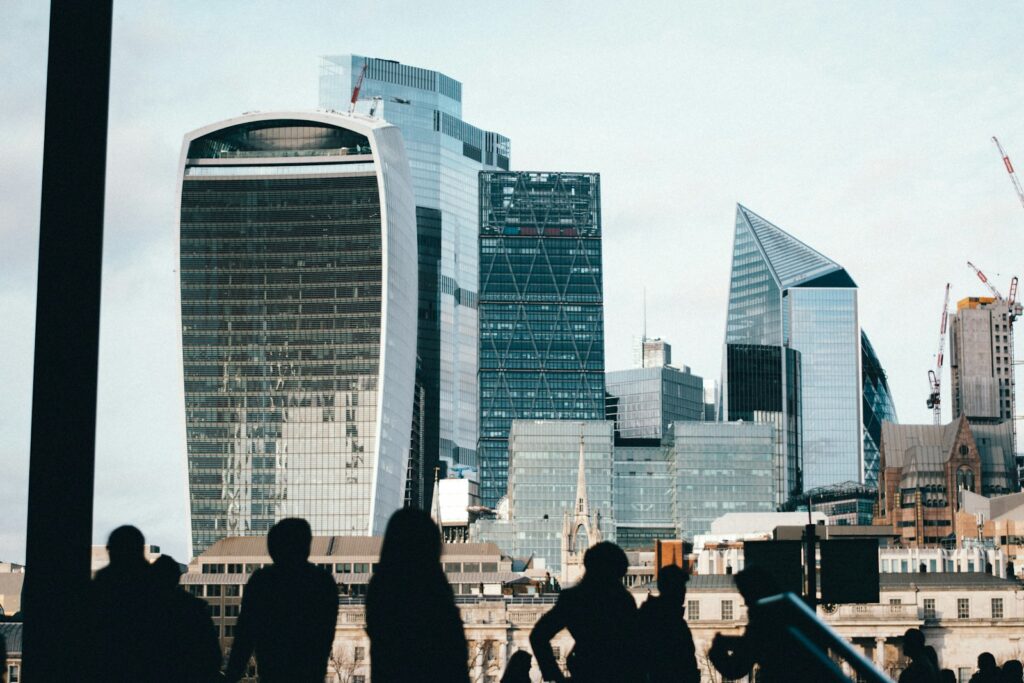 a group of people standing in front of tall buildings