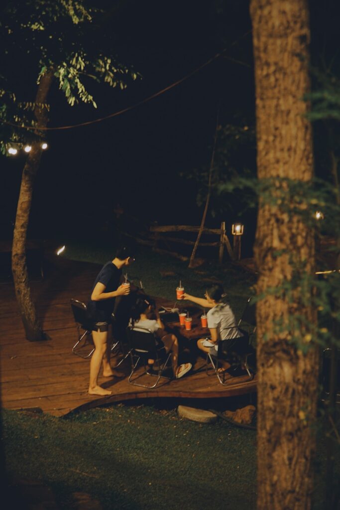 Friends gathered around a table at night.